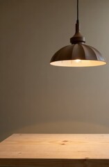 close-up of minimalist modern brown pendant lamp, hanging above neutral-toned wooden table. interior design, home decor, lighting inspiration.