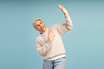 Scared woman protecting herself from something disgusting falling from above