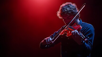 Fototapeta premium A Musician Passionately Plays A Red Violin