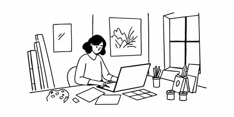 Creative young woman working on laptop in her studio
