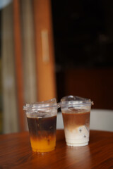 two cups of ice coffee on the wood table