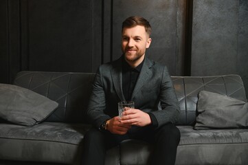 Portrait of a handsome man in an elegant suit on a grunge background
