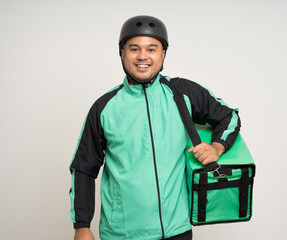 Young asian rider wearing green jacket uniform and bike helmet various action with delivery box. Male delivery service worker. Courier and shipping food service to customer online application