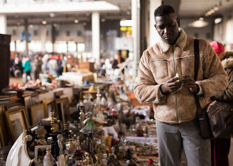Man chooses antiques at a flea market