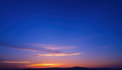 Obraz premium view of a sunset over a body of water, blue sky at sunset