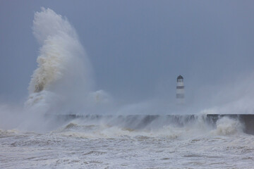 Waves crashing over the sea defence at Seaham, County Durham, England UK.