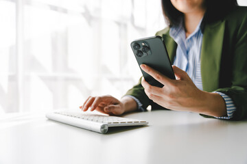 Typing on a smartphone Working online on laptop, computer and smartphone on white table at office. Facebook chat. Web meeting. Blogger. Journalist writing an article. online job idea