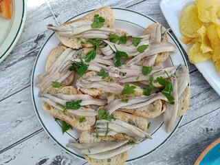 Tipical Spanish food. Pickled raw anchovies marined with olive oil, garlic, vinegar, lemon and parsley.