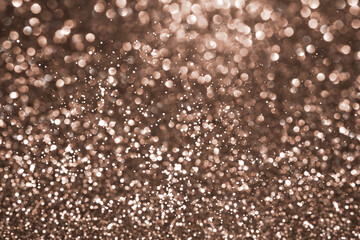 Mocha Mousse, brown sparkling glitter bokeh background, abstract defocused texture. Holiday lights. Demonstrating color, trend 2025 year