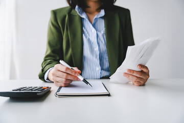 Portrait of a young woman calculating the bill for expenses to be paid. Financial concepts, debt...