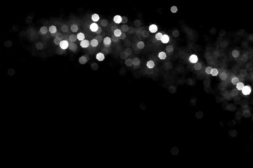 White gray blurred bokeh lights on black background