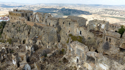 Aerial view of abandoned and destroyed houses in Craco, ghost town in province of Matera,...