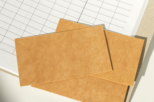 Blank brown cards on open spreadsheet indoors