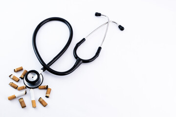 Stethoscope and smoked cigarettes with copy space.