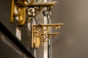 Decorative metal shelf brackets in various styles on display.
