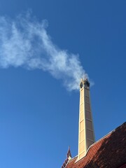 The cremation of a lifeless person has smoke coming out of the vent. The temple is a quiet place. The temple is a place to practice Dhamma and pray with a peaceful mind.