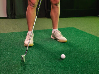 Golfer enjoys playing golf at driving range