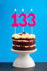 Red velvet birthday cake with number 133 candle