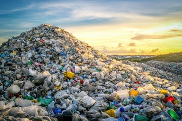 A large pile of plastic waste exists in the center of a field
