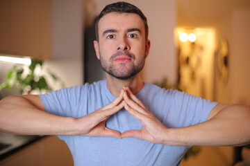 Man making a weird triangular symbol with his hands 