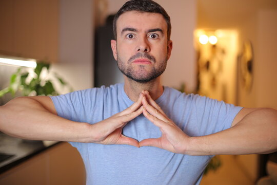 Man making a weird triangular symbol with his hands 