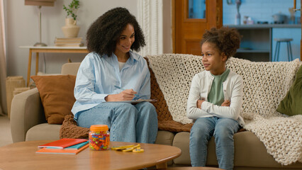 African American mother daughter child study development conversation talk gesture smile treatment speech speak healthcare support offspring females maternity childcare home living room family leisure