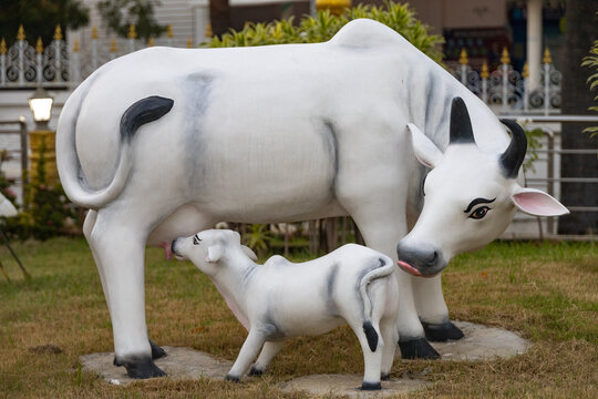 Divine cow and calf idol representing motherhood and compassion
