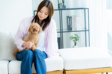 部屋でペットとくつろぐ若い女性