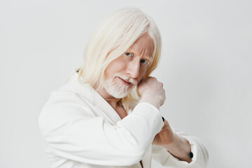 Elderly man with long white hair in a white robe posing against a light background, showcasing confidence and serenity in an artistic portrait style