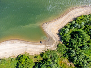 Aerial View of a Serene Lake Shoreline with Lush Greenery
