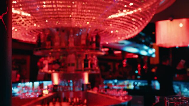 Experience a glamorous nightclub atmosphere filled with captivating red lighting and an elegant bar setting