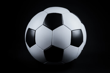Fototapeta premium A crisp black-and-white soccer ball with a smooth texture and polished panels, shown against a soft dark background.