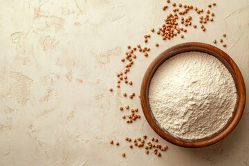 Buckwheat flour in a wooden bowl and raw buckwheat grain on beige monochrome background, close up. Alternative flour, gluten free flour, healthy nutrition