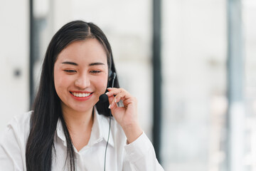 Smiling woman with headset working in customer service