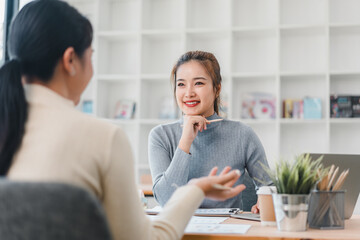 Two women having professional discussion in modern office