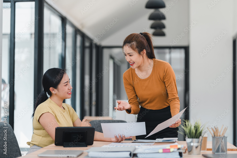 Canvas Prints Two women discussing work in modern office space