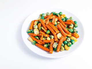 Mixed snacks in white plate isolated on white background,containing nuts and cake sticks in various flavors and colors