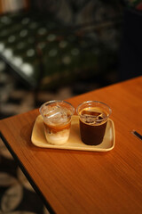 two cups of ice coffee on the wood table
