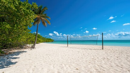 Fototapeta premium A sandy beach volleyball court with a net and a clear ocean view in the background.