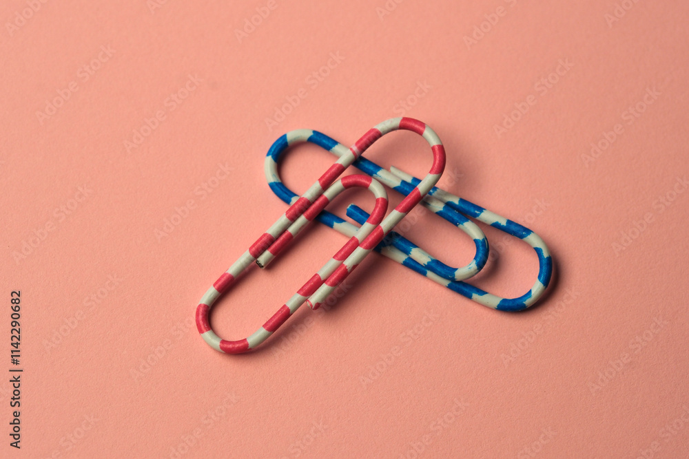 Poster colorful paperclips create an abstract pattern on soft pastel background