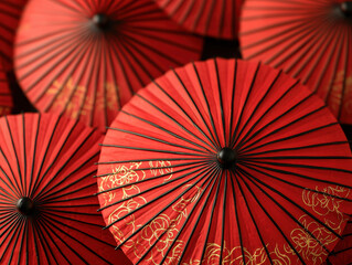Red parasols with intricate gold designs create vibrant pattern
