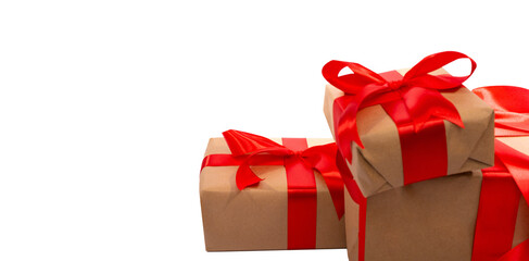 A set of gift boxes carefully wrapped and tied with red satin ribbons and bows, arranged on an impeccable isolated background. Ideal for festive occasions and celebrations.