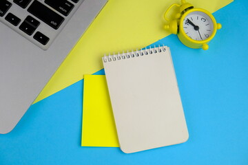 Home office workspace mockup with laptop, clipboard, palm leaf, notebook and accessories. Flat lay,...