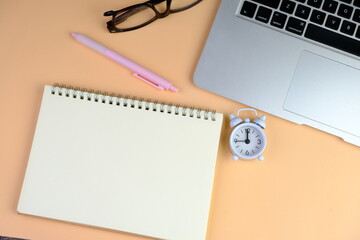 Home office workspace mockup with laptop, clipboard, palm leaf, notebook and accessories. Flat lay,...