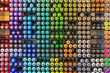 Spray paint aerosol cans organized colors stacked.