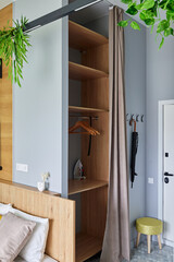 A modern bedroom with a stylish closet and natural elements for a calming ambiance