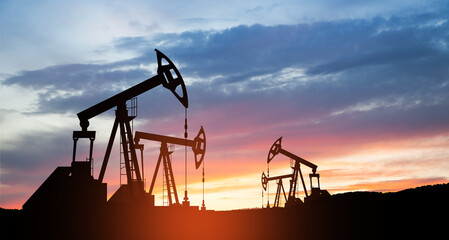 The change in oil prices caused by the war. Oil price cap concept. Oil drilling derricks at desert oilfield. Crude oil production from the ground. Petroleum production.