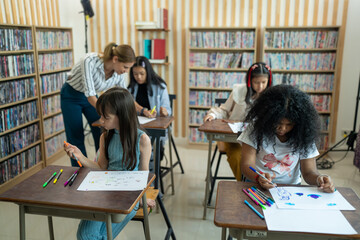 Creative Art Class Takes Place in a Modern Classroom Filled With Books Where Young Students Explore Their Artistic Skills With Colorful Markers