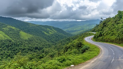 Fototapeta premium Scenic Winding Road Through Lush Green Mountain Landscape