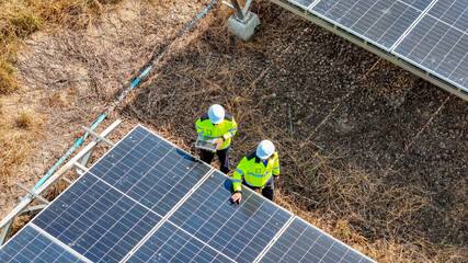 Workers Inspect Solar Panels in a Rural Area During Bright Sunlight